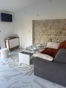 a living room with a couch and a table at La Suite du Maine SAINTES in Saintes
