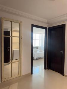 an empty room with a door and a bedroom at Le charbon élégant in Bin Rhilouf +4 photos