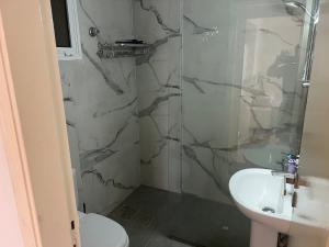 a bathroom with a toilet and a sink at Cozy appartment in hrajel in Dir‘alī +23 photos