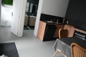 a kitchen with a table and a sink and a stove at Chez Rachel in Mérélessart +1 photo