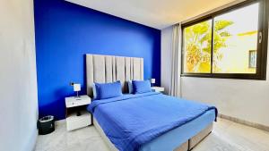 a blue bedroom with a bed with blue walls at Cozy appartement Marrakech in Marrakesh +56 photos
