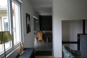 a living room with a table and a dining room at Chez Rachel in Mérélessart