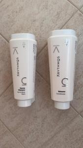 two white cups sitting on a tile floor at Casa Rasiglia 2 House Smart in Casenove