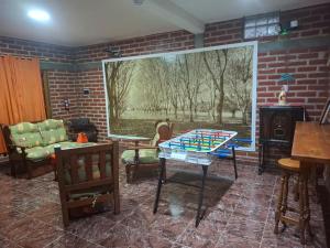 a living room with a table and a brick wall at El Belichito in Belén