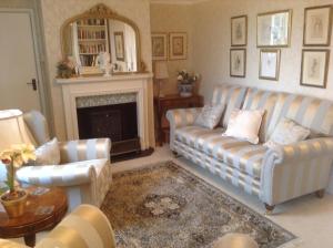 a living room with two couches and a fireplace at Manor Farm in Poundon