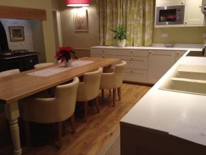 a kitchen with a large wooden table and chairs at Manor Farm in Poundon