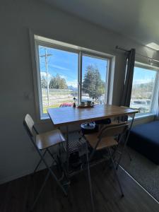 a table and two chairs in a room with a window at Texada Hunter Hiker friendly suite in Vananda