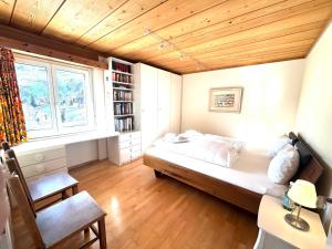 a small bedroom with a bed and a window at Mountain View in Andermatt