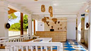 a man sitting at a table in a restaurant at The Trawangan Resort in Gili Trawangan