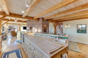 a large kitchen with wooden ceilings and wooden counters at Oceanaire in Dennis +37 photos