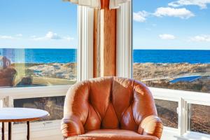 a leather chair sitting in front of a large window at Oceanaire in Dennis