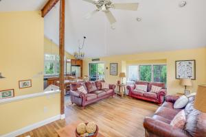 a living room with couches and a dining room at Pleasant Point in Wellfleet