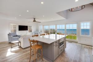 a kitchen and living room with a view of the ocean at Sea Winds in Brewster +76 photos