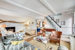 a living room filled with furniture and a staircase at The Cook House in Provincetown +61 photos