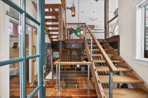 a spiral staircase in a room with wooden floors at The Grand On Commercial in Provincetown