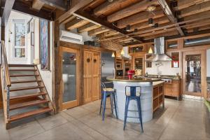 a kitchen with wooden ceilings and a stove top oven at The Grand On Commercial in Provincetown
