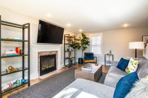 a living room with a couch and a fireplace at Cod Hollow in Provincetown +13 photos