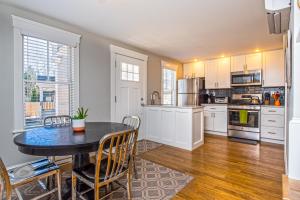 a kitchen with a table and chairs in a room at Cod Hollow in Provincetown