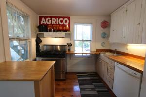 a kitchen with an acredo sign on the wall at High Tide Lower Level in Provincetown