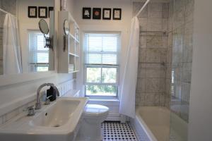 a bathroom with a sink and a toilet and a shower at High Tide Upper Level in Provincetown