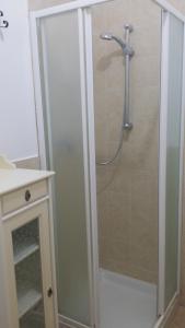 a shower with a glass door in a bathroom at Monolocale Lori in Montefalco