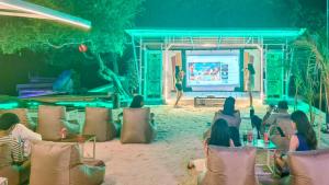 a group of people watching a presentation on a stage at The Trawangan Resort in Gili Trawangan +229 photos