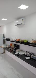 a kitchen with a counter with some food on it at Hotel Arco-Íris in Itapipoca