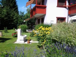 a garden in front of a building with flowers at Apartment mit Balkon by Interhome in Gorje +43 photos