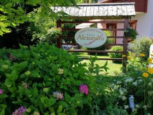 a garden in front of a sign with flowers at Apartment mit Balkon by Interhome in Gorje