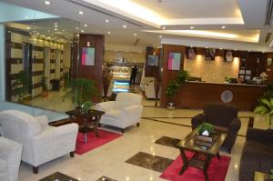a lobby with chairs and tables in a store at Jowharet AlMaseya in Al Khobar +181 photos