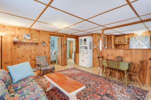 a living room with a couch and a table at Anchors Aweigh in Brewster