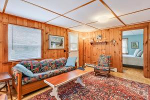 a living room with a couch and a table at Anchors Aweigh in Brewster
