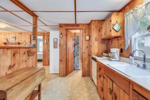 a kitchen with wooden cabinets and a sink at Anchors Aweigh in Brewster +9 photos