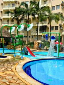 a pool with a water park with a slide at Thermas Paradise Residence in Rio Quente