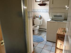 a small bathroom with a toilet and a sink at Bayside Bliss in Dennis