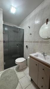a bathroom with a shower and a toilet and a sink at Apto 2D ensolarado, sacada e garagem, centro in Nova Petrópolis +19 photos