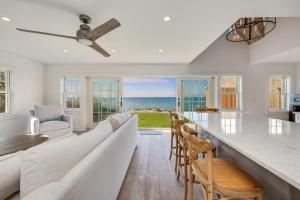 a living room with a large couch and chairs at Sea Winds in Brewster