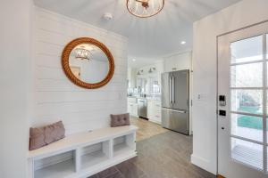 a white kitchen with a mirror on the wall at Sea Winds in Brewster