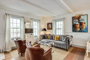 a living room with a couch and a tv at The Cook House in Provincetown