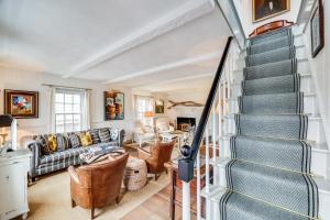 a living room with a staircase and a couch at The Cook House in Provincetown