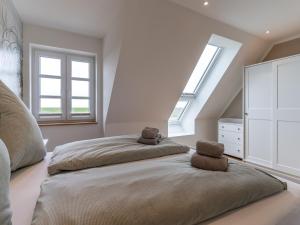 a bedroom with a bed with two stuffed animals on it at Doppelhaushälfte in Karolinenkoog in Karolinenkoog