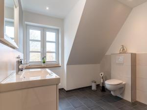a bathroom with a sink and a toilet at Doppelhaushälfte in Karolinenkoog in Karolinenkoog +18 photos