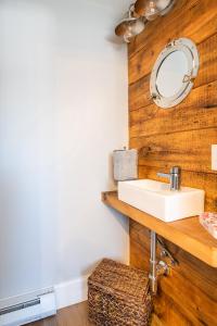 a bathroom with a sink and a mirror at Cod Hollow in Provincetown