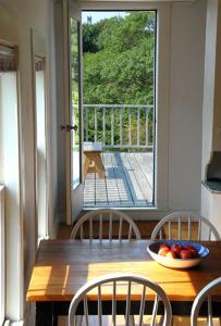 a wooden table with chairs and a bowl of fruit on it at High Tide Upper Level in Provincetown +11 photos