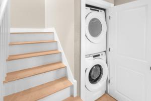 a laundry room with a washer and dryer at Harbor Hideaway in Provincetown +12 photos