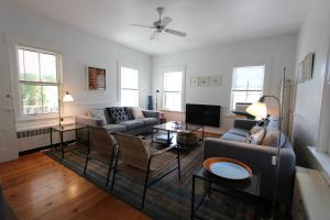 a living room with two couches and a tv at High Tide Lower Level in Provincetown