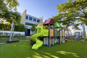 a playground with a slide on the grass at Casa Piedra Villa in Cancún