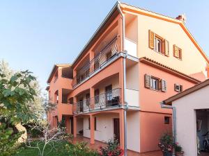 an orange and white building with balconies at Apartments Cvek in Rovinj +116 photos