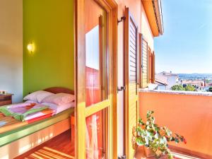 a room with a bed on a balcony with a window at Apartments Cvek in Rovinj