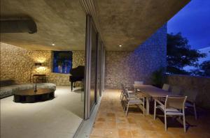a room with a table and chairs and a couch at Casa Piedra Villa in Cancún